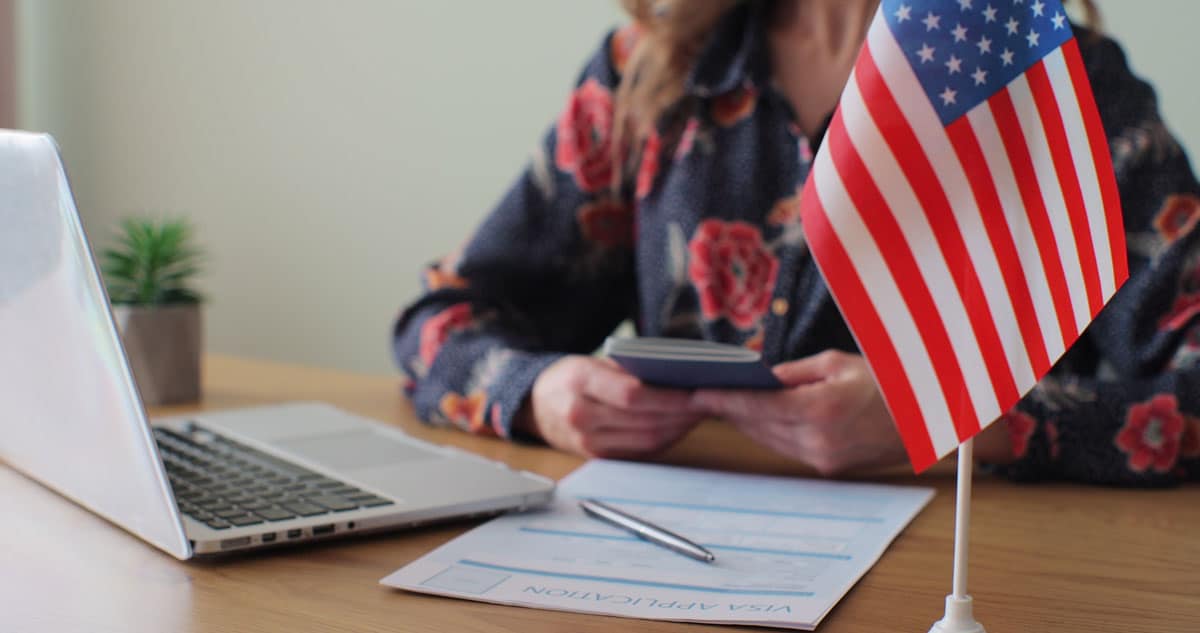 A woman at an American consular office holds her passport