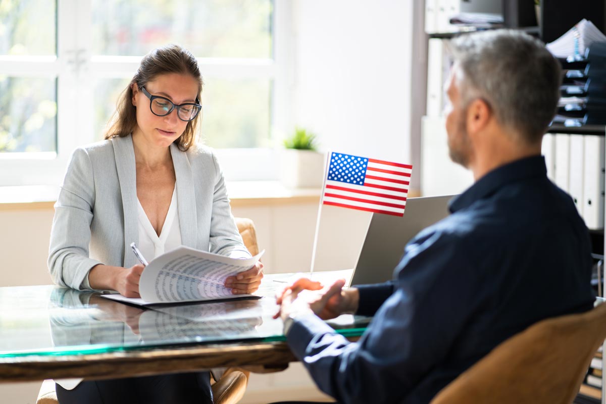 An O1 visa holder sits in an immigration office