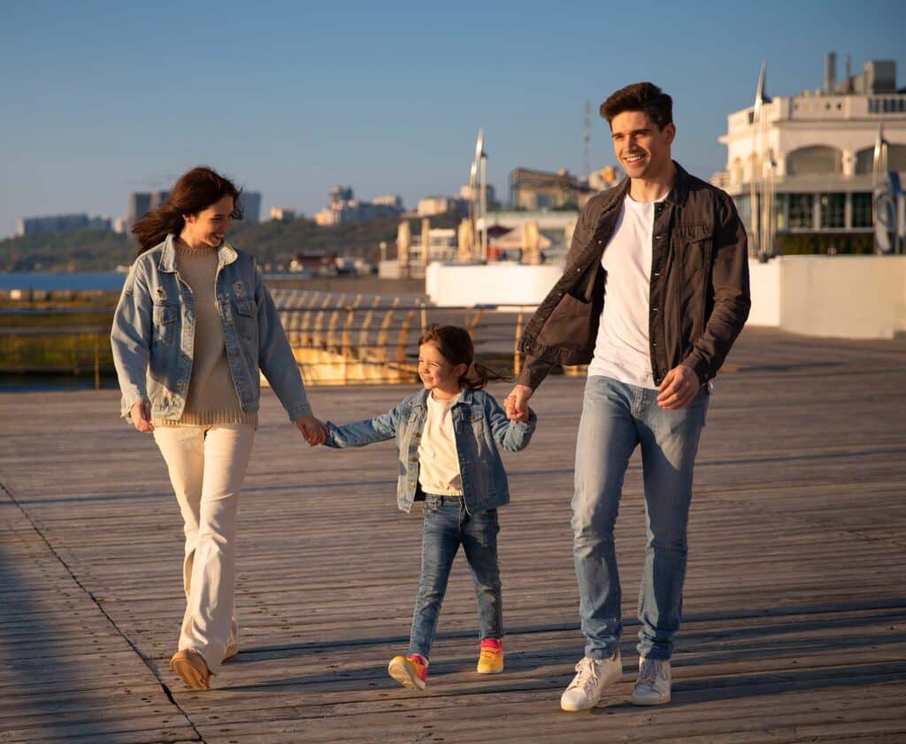 Family walking in port, sunny
